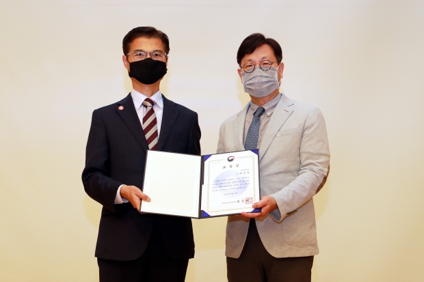 삼육대 김일목 총장이 음악학과 박정양 교수에게 교육부장관 표창장을 전수하고 있다