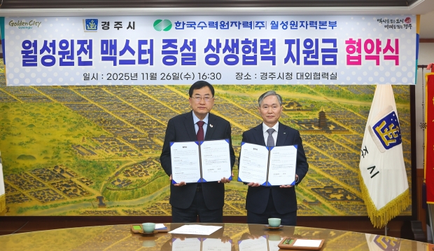 주낙영 경주시장(왼쪽)과 권원택 한국수력원자력 월성원자력본부장이 26일 경주시청 대외협력실에서 월성원전 맥스터 증설 상생협력 지원금 협약을 체결한 뒤 협약서를 들어 보이고 있다